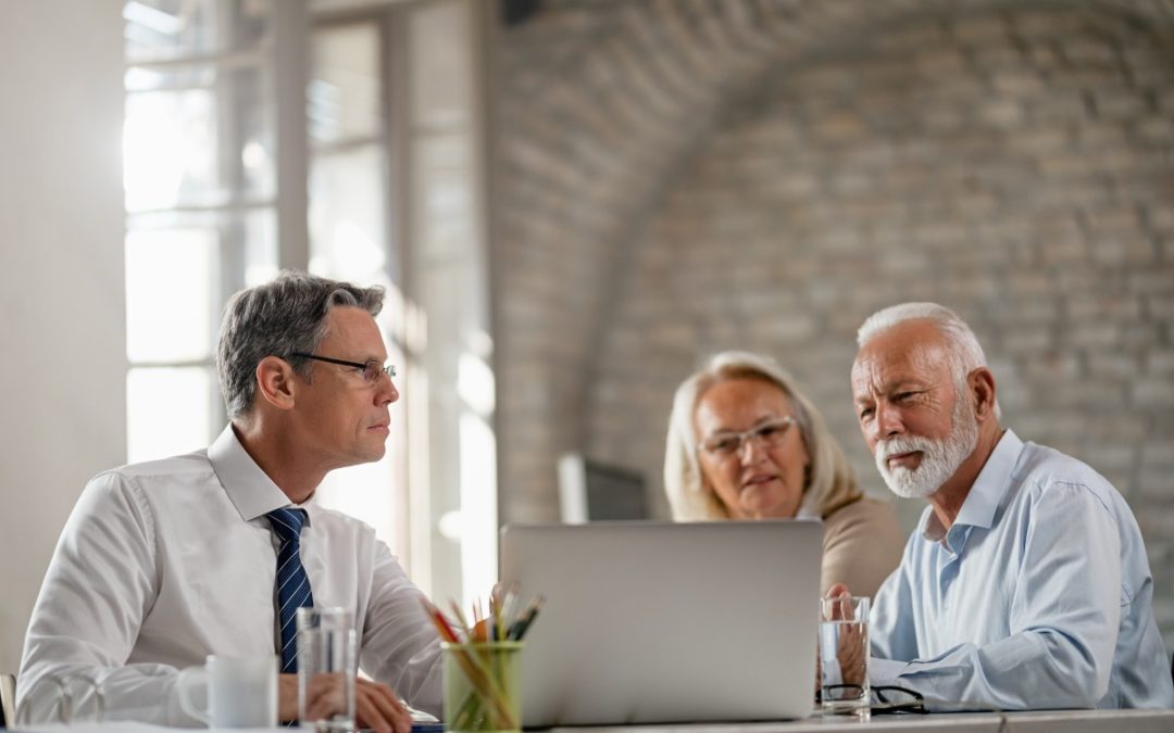 Financial advisor meeting with senior couple discussing retirement planning under the SECURE 2.0 Act