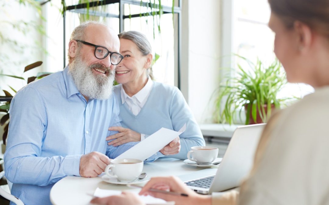 Senior couple reviewing retirement plan with advisor to optimize Roth conversions and reduce tax burden.